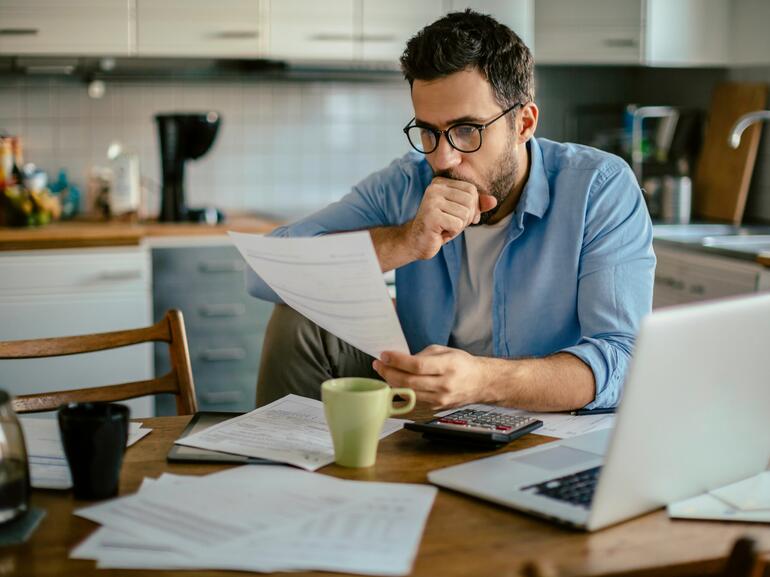 Man looking at his bills and home finances